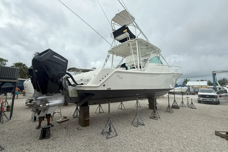 Absent Minded Yacht Photos Pics 2014 SeaVee 430 boat on stands, featuring Mercury outboard engines, in a boatyard setting.