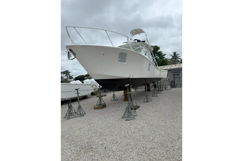 Absent Minded Yacht Photos Pics 2014 SeaVee 430 boat on stands, displayed outdoors under cloudy skies.