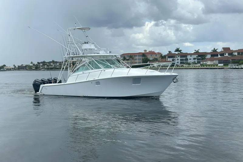 Absent Minded Yacht Photos Pics 2014 SeaVee 430 boat cruising on calm waters near residential area.