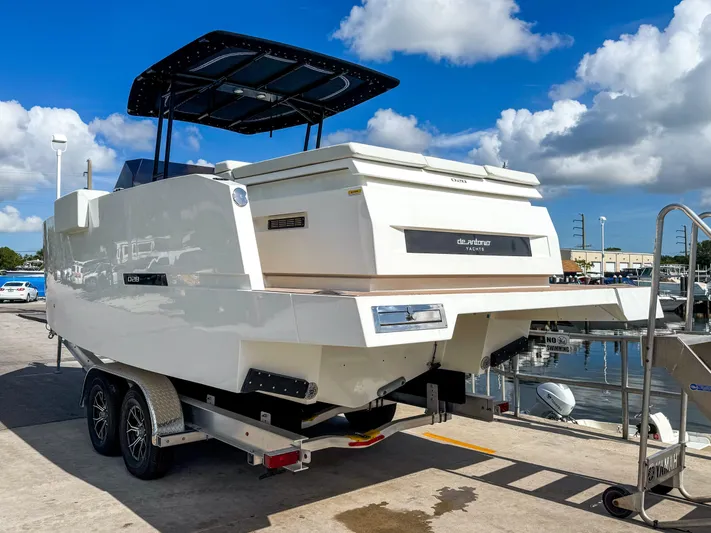  Yacht Photos Pics 2024 De Antonio Yachts D28 Open on trailer, dockside under blue sky.