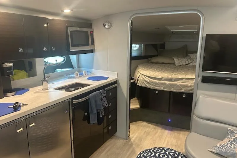 Sea Star Yacht Photos Pics Interior of a 2018 Formula 40 Performance Cruiser with modern kitchen and cozy sleeping area.