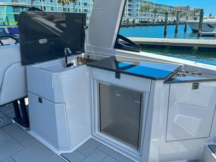  Yacht Photos Pics 2020 Aviara AV32 OB boat interior with kitchenette and waterfront view.