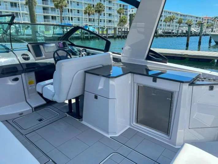  Yacht Photos Pics 2020 Aviara AV32 OB boat interior with helm, seating, and waterfront view.