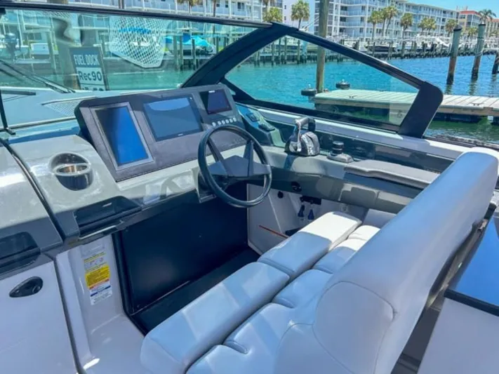  Yacht Photos Pics 2020 Aviara AV32 OB boat cockpit with modern controls and waterfront view.