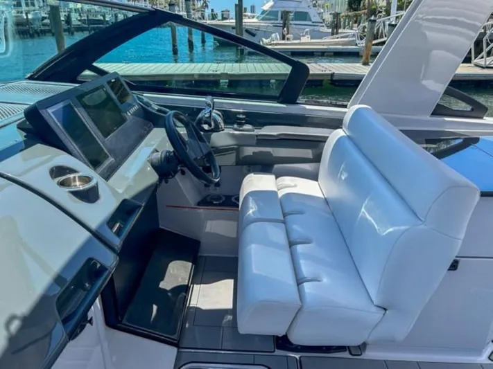  Yacht Photos Pics 2020 Aviara AV32 OB boat cockpit with white seating and modern dashboard.