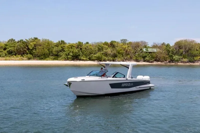  Yacht Photos Pics 2020 Aviara AV32 OB boat cruising near a lush shoreline.