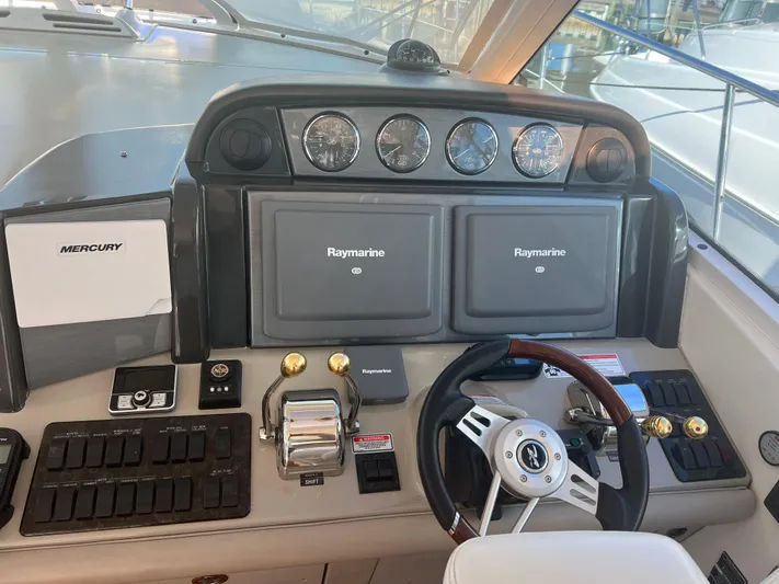  Yacht Photos Pics Control panel of a 2006 Sea Ray 48 Sundancer yacht with Raymarine displays and Mercury controls.