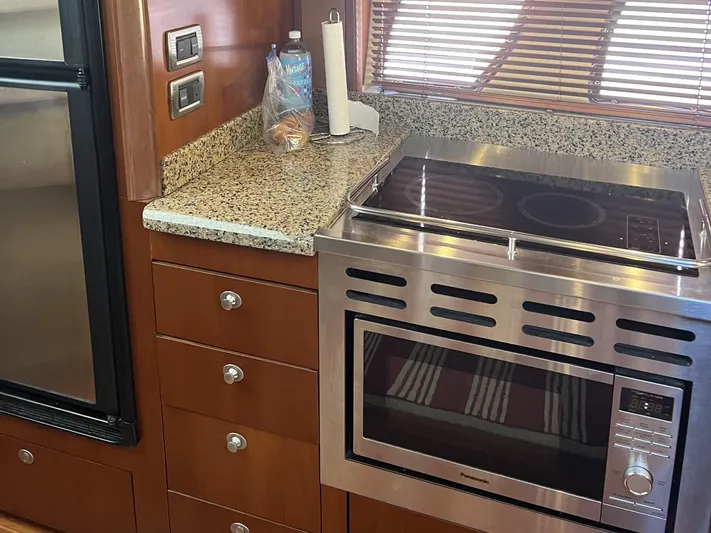  Yacht Photos Pics Kitchen area of 2006 Sea Ray 48 Sundancer with granite countertop and stainless steel appliances.