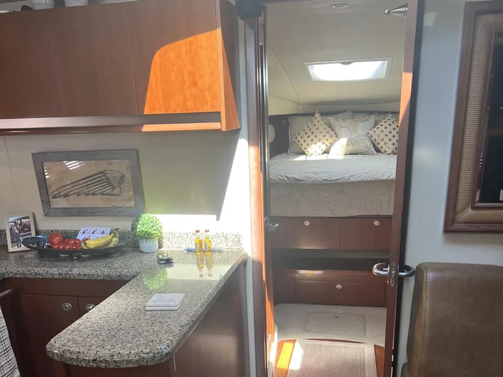  Yacht Photos Pics Interior of 2006 Sea Ray 48 Sundancer yacht with cozy bedroom and modern kitchen.