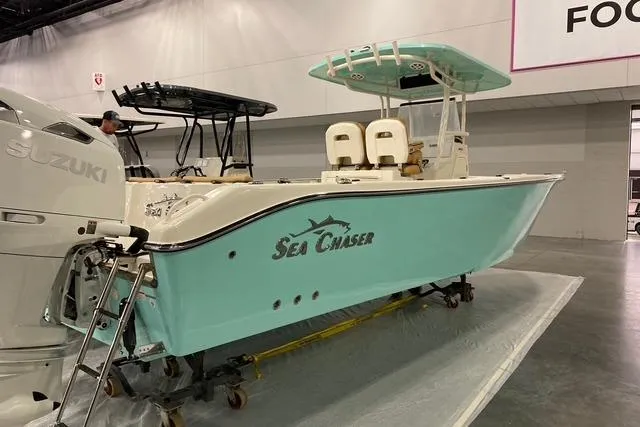  Yacht Photos Pics 2026 Sea Chaser 30 HFC CC boat with Suzuki engine, displayed indoors.
