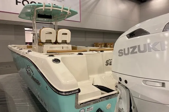  Yacht Photos Pics 2026 Sea Chaser 30 HFC CC boat with Suzuki engine, displayed indoors.