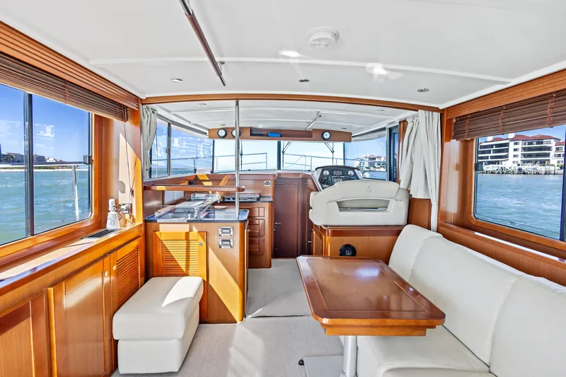 Lady Di Yacht Photos Pics Interior of 2012 Beneteau Swift Trawler 44, featuring elegant wood finishes and spacious seating.