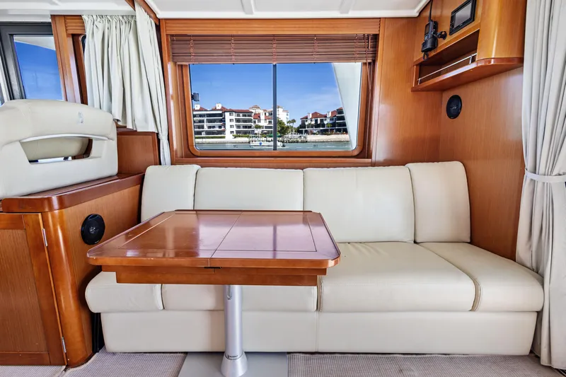 Lady Di Yacht Photos Pics Interior of 2012 Beneteau Swift Trawler 44 with sofa and wooden table.