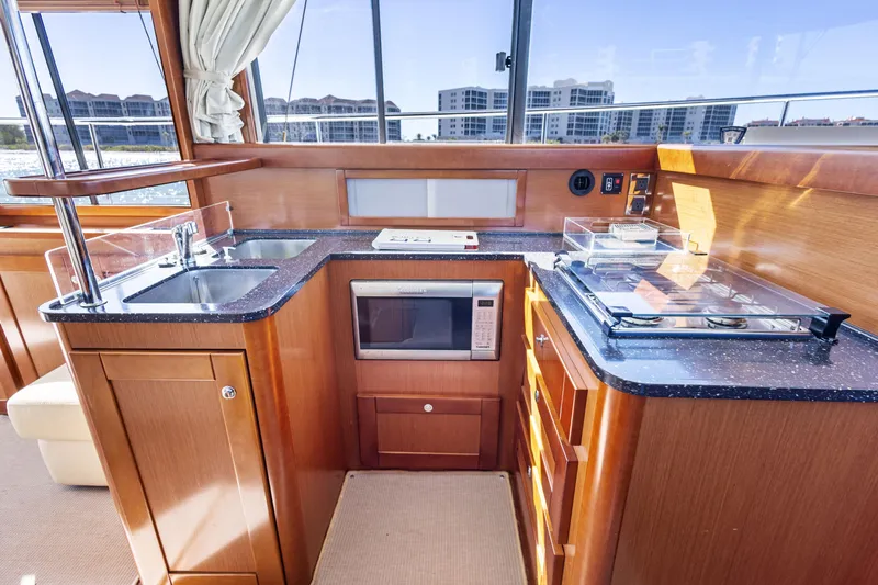 Lady Di Yacht Photos Pics Interior of 2012 Beneteau Swift Trawler 44 kitchen with modern appliances and wood cabinetry.