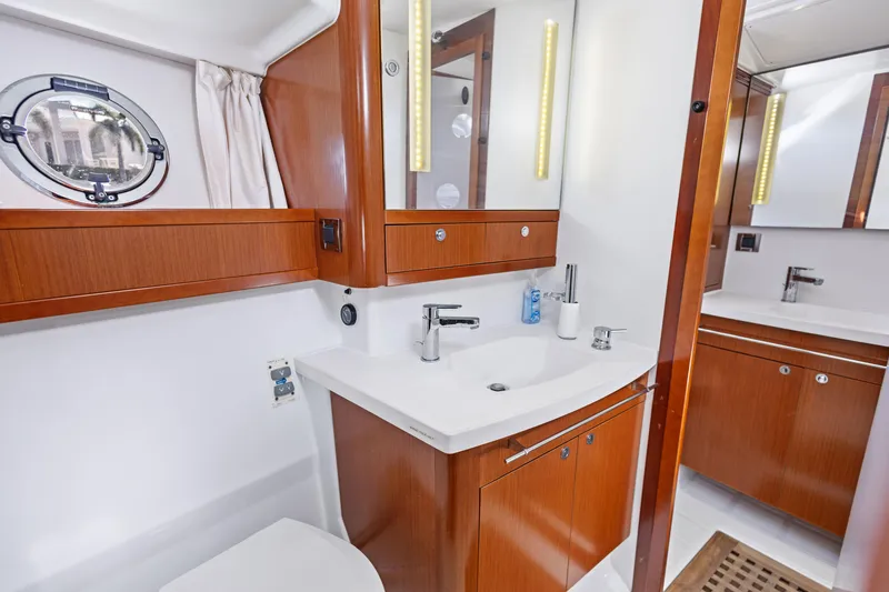 Lady Di Yacht Photos Pics Luxurious bathroom in 2012 Beneteau Swift Trawler 44 with wood cabinetry and modern fixtures.