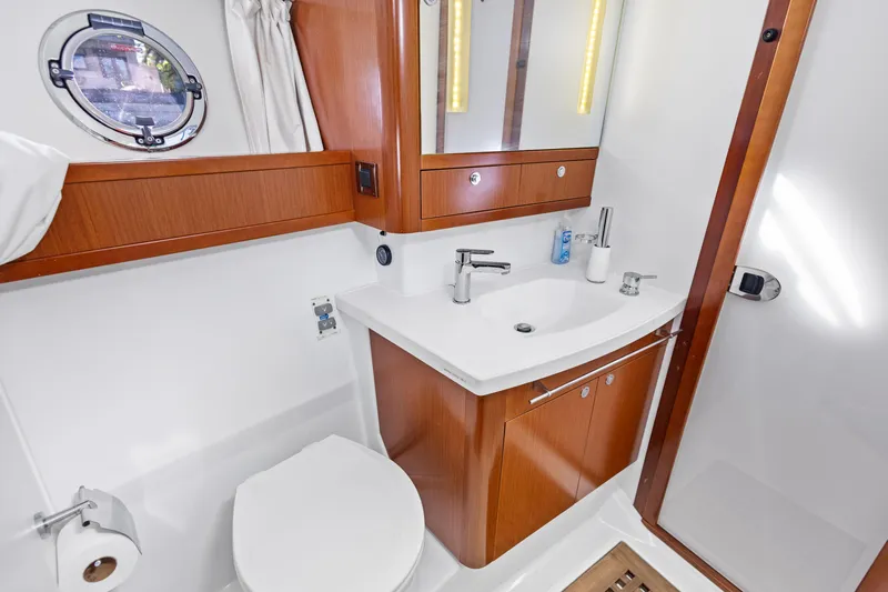 Lady Di Yacht Photos Pics 2012 Beneteau Swift Trawler 44 bathroom with wooden cabinetry and modern fixtures.