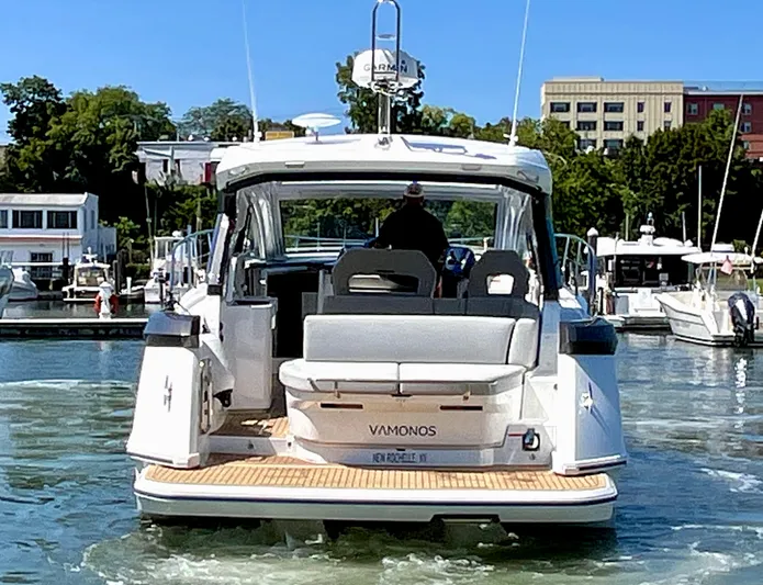 Vamanos Yacht Photos Pics 2023 Beneteau Gran Turismo 41 yacht docked in a marina, rear view.