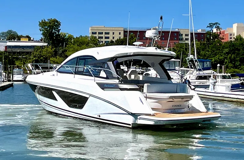 Vamanos Yacht Photos Pics 2023 Beneteau Gran Turismo 41 yacht docked in marina, sunny day.