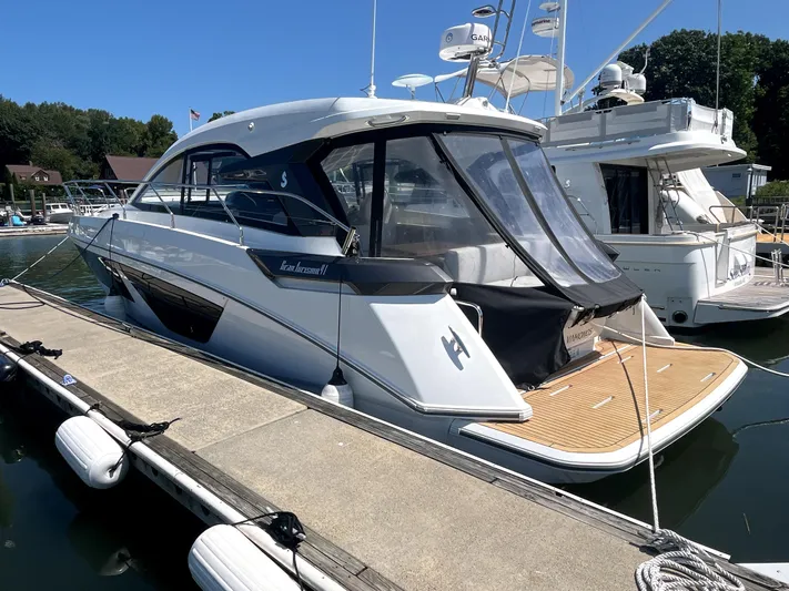 Vamanos Yacht Photos Pics 2023 Beneteau Gran Turismo 41 yacht docked at marina, rear view.