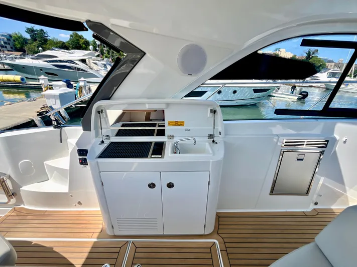 Vamanos Yacht Photos Pics Interior of 2023 Beneteau Gran Turismo 41 yacht with sleek kitchenette and modern design.