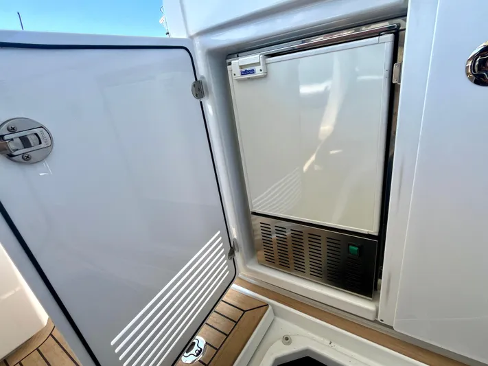 Vamanos Yacht Photos Pics Beneteau Gran Turismo 41, 2023 model, featuring a built-in refrigerator with open door.