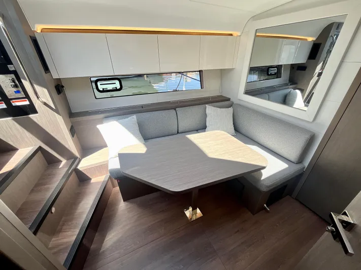 Vamanos Yacht Photos Pics Luxurious interior of 2023 Beneteau Gran Turismo 41 yacht with modern seating and table.
