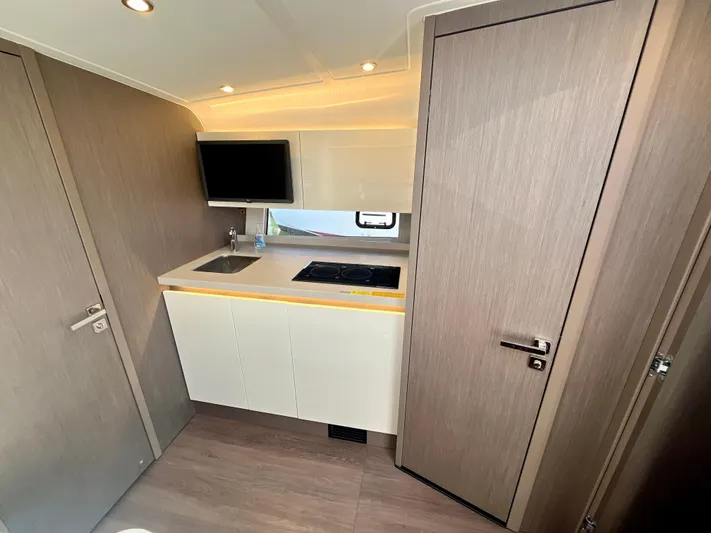 Vamanos Yacht Photos Pics Modern kitchen interior of 2023 Beneteau Gran Turismo 41 yacht with sleek cabinetry and appliances.