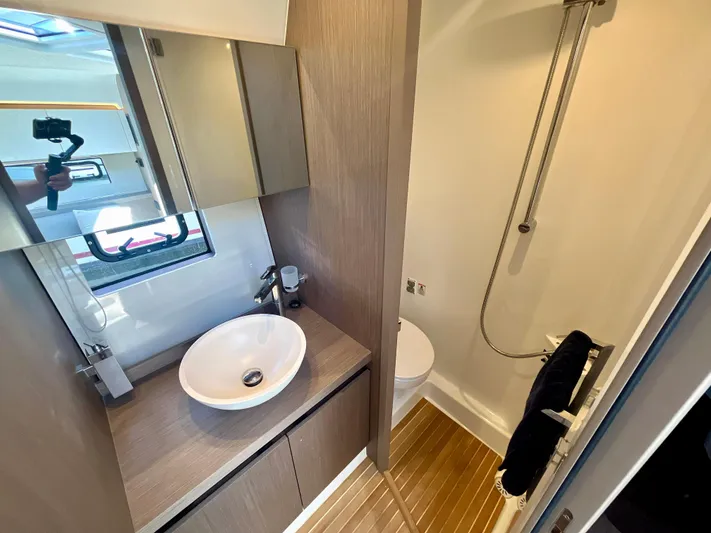 Vamanos Yacht Photos Pics Modern bathroom in 2023 Beneteau Gran Turismo 41 yacht with sleek fixtures and wood accents.