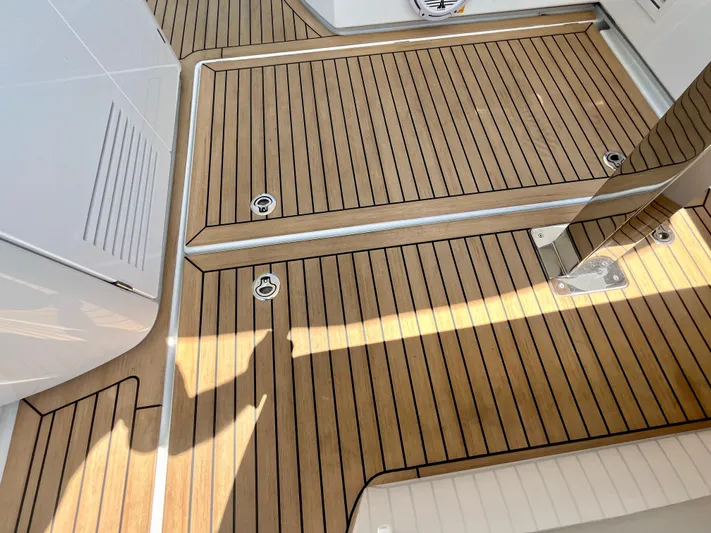 Vamanos Yacht Photos Pics Teak deck of 2023 Beneteau Gran Turismo 41 yacht, showcasing elegant wood finish.