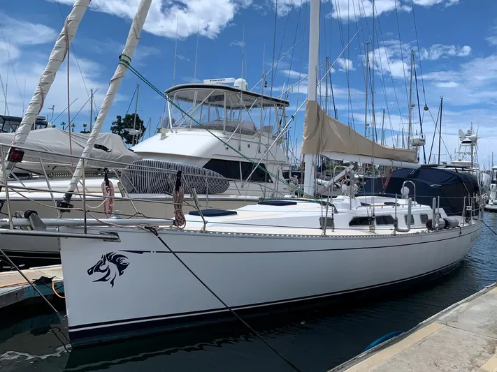 Wild Horses Yacht Photos Pics Sailboat docked at marina, Saga 43 model, 2002, with clear blue sky background.