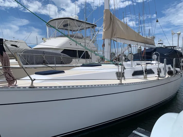 Wild Horses Yacht Photos Pics Saga 43 sailboat from 2002 docked at a marina under a partly cloudy sky.