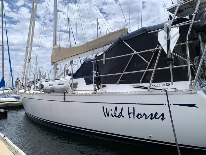 Wild Horses Yacht Photos Pics 2002 Saga 43 sailboat named "Wild Horses" docked at a marina.
