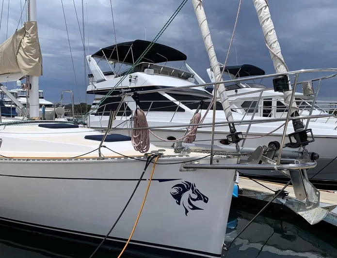 Wild Horses Yacht Photos Pics Saga 43 sailboat from 2002 docked at marina, featuring sleek design and nautical emblem.