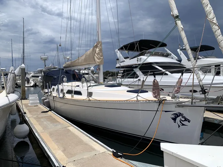 Wild Horses Yacht Photos Pics Saga 43 sailboat from 2002 docked at a marina under cloudy skies.