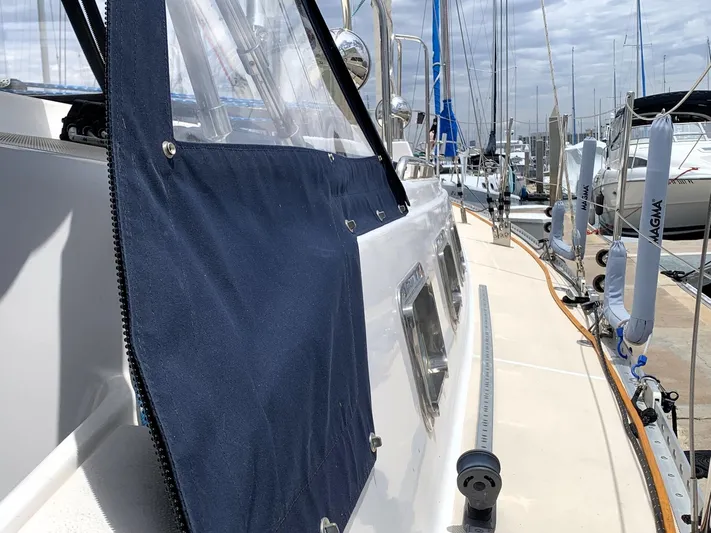 Wild Horses Yacht Photos Pics Saga 43 sailboat from 2002 docked at a marina, featuring a blue canvas cover.