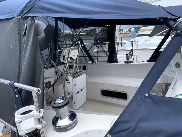 Wild Horses Yacht Photos Pics Cockpit of 2002 Saga 43 sailboat with blue canopy and steering wheel.