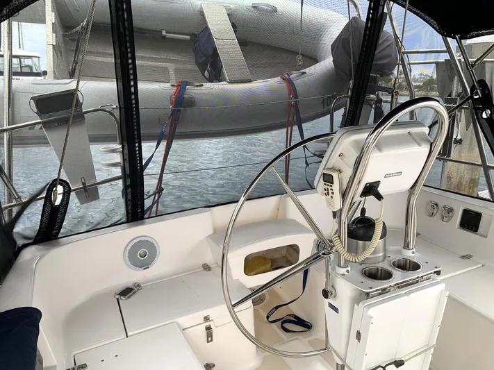 Wild Horses Yacht Photos Pics Cockpit of 2002 Saga 43 sailboat with steering wheel and dinghy in background.