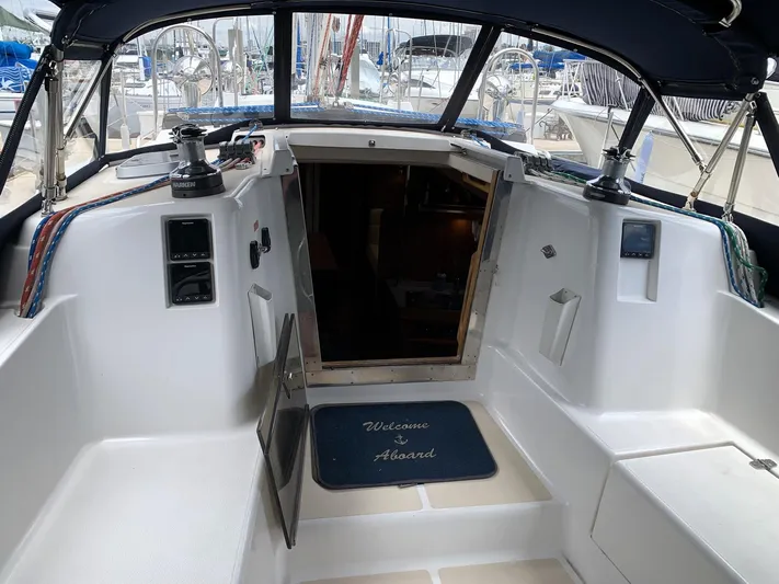 Wild Horses Yacht Photos Pics Cockpit of 2002 Saga 43 sailboat with "Welcome Aboard" mat and nautical equipment.