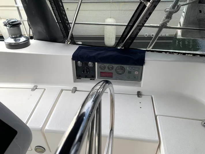 Wild Horses Yacht Photos Pics Control panel of a 2002 Saga 43 sailboat cockpit with steering wheel and winch.