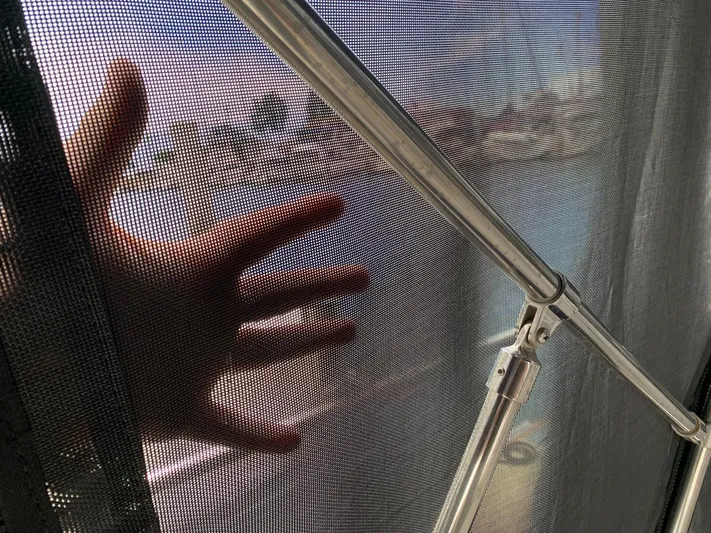 Wild Horses Yacht Photos Pics Hand pressing against mesh screen on Saga 43, 2002 model boat.