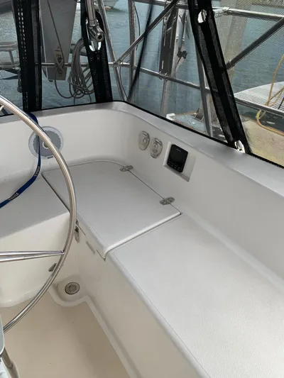 Wild Horses Yacht Photos Pics Interior view of a 2002 Saga 43 sailboat cockpit with steering wheel and controls.