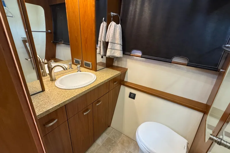  Yacht Photos Pics Luxurious bathroom in 2014 Tiara Yachts 5800 Sovran with elegant wood cabinetry.