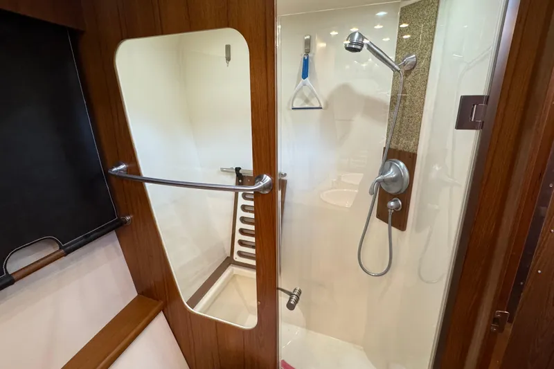  Yacht Photos Pics Luxurious shower area in 2014 Tiara Yachts 5800 Sovran, featuring modern fixtures and wood accents.