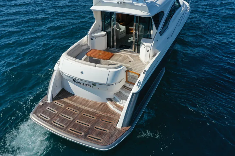  Yacht Photos Pics 2014 Tiara Yachts 5800 Sovran cruising on open water, rear view.