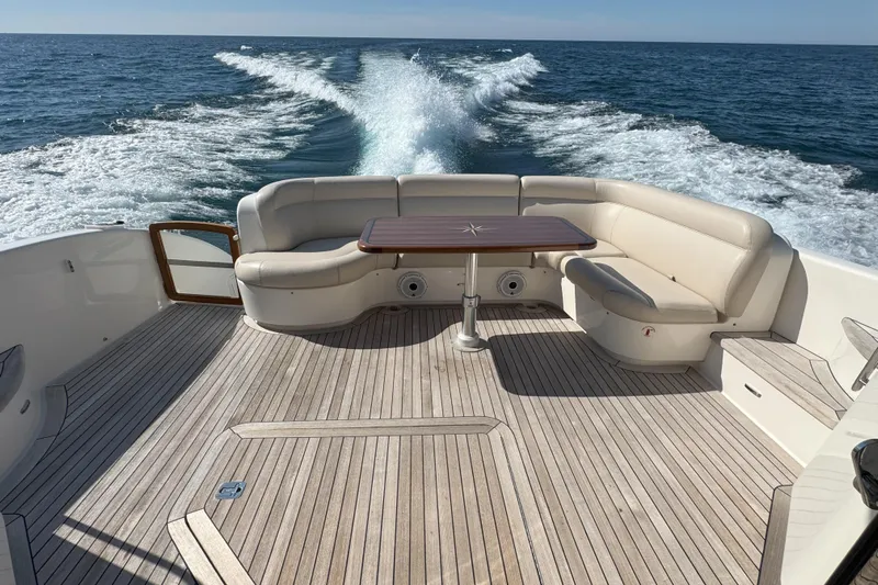  Yacht Photos Pics 2014 Tiara Yachts 5800 Sovran cruising, featuring spacious deck and seating area.