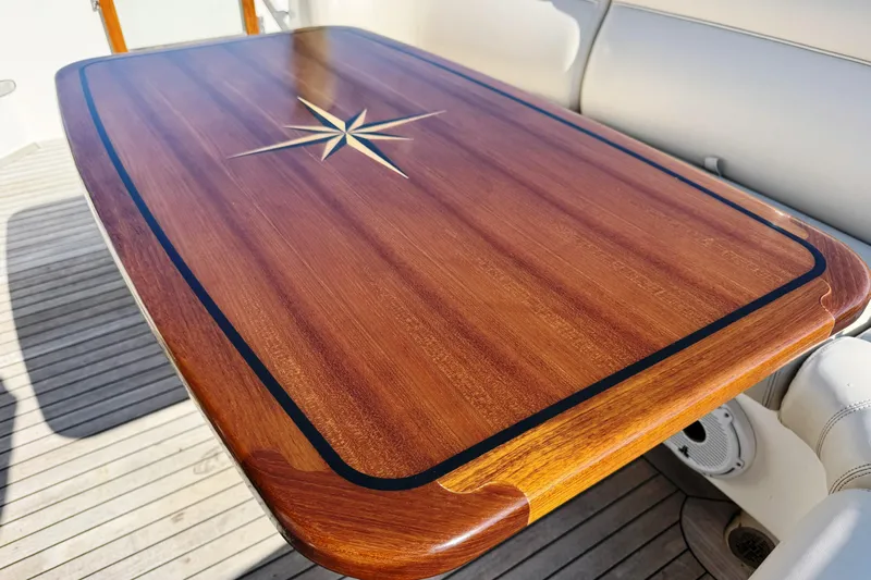  Yacht Photos Pics Luxurious wooden table with star inlay on 2014 Tiara Yachts 5800 Sovran.