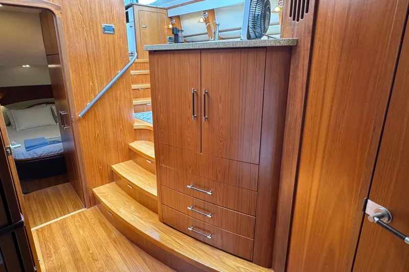  Yacht Photos Pics Luxurious wooden interior of 2014 Tiara Yachts 5800 Sovran with stairs and cabinetry.