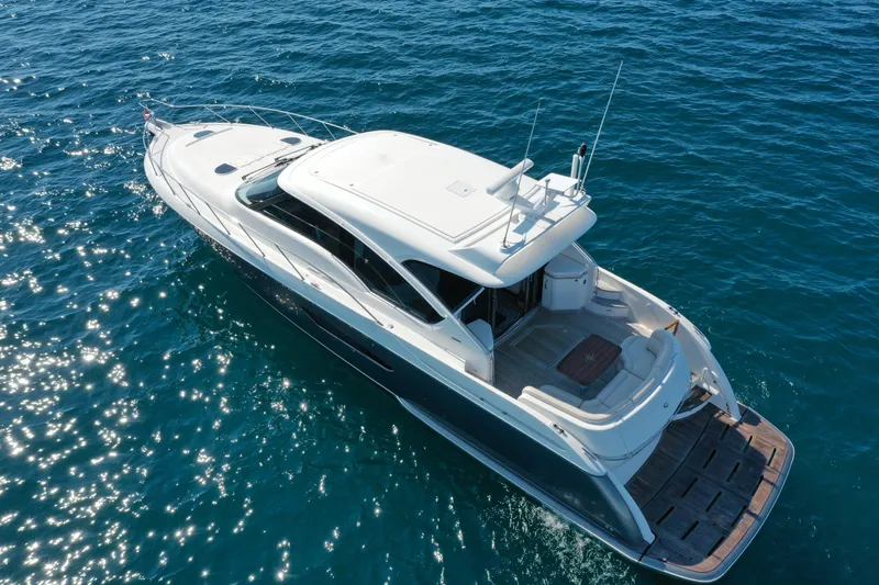  Yacht Photos Pics 2014 Tiara Yachts 5800 Sovran cruising on clear blue water.