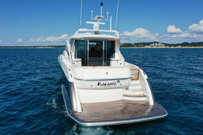  Yacht Photos Pics 2014 Tiara Yachts 5800 Sovran on open water, rear view with clear skies.