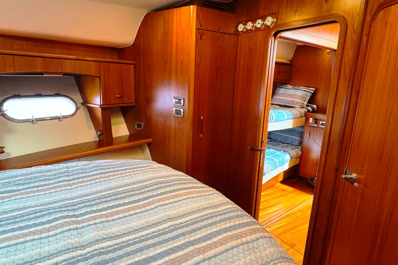  Yacht Photos Pics Luxurious 2014 Tiara Yachts 5800 Sovran cabin with wood interior and cozy bedding.